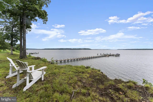 a view of a lake with a table and chairs