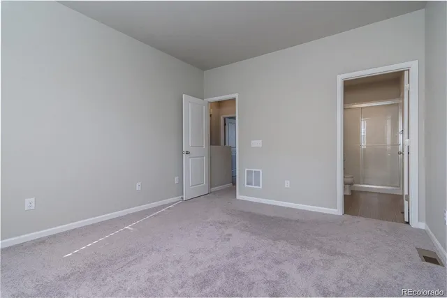 a view of an empty room and closet area