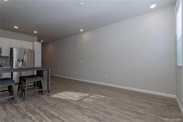 a view of kitchen with furniture and wooden floor