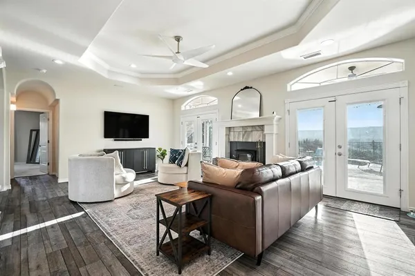 a living room with furniture a fireplace and a flat screen tv