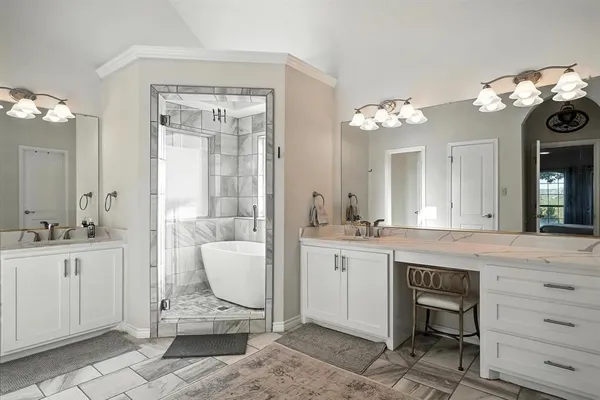 a spacious bathroom with a granite countertop sink a toilet and a mirror