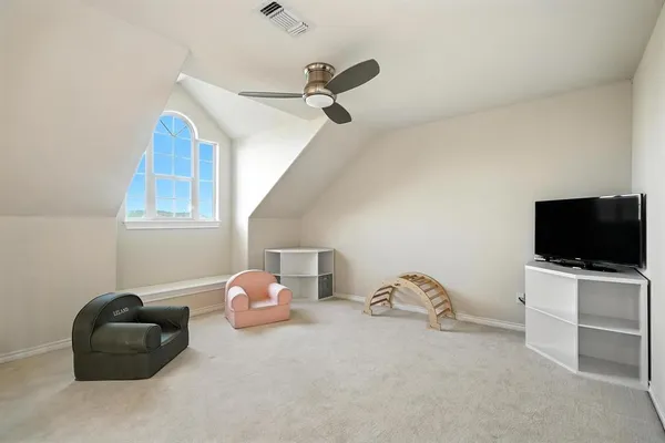 a bedroom with a bed and a flat tv screen