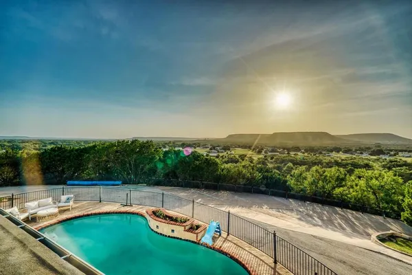 a view of a swimming pool with a patio