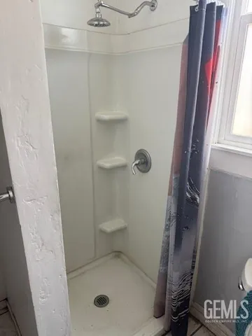 a bathroom with a toilet and a shower