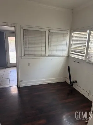 a view of a livingroom with wooden floor and a window