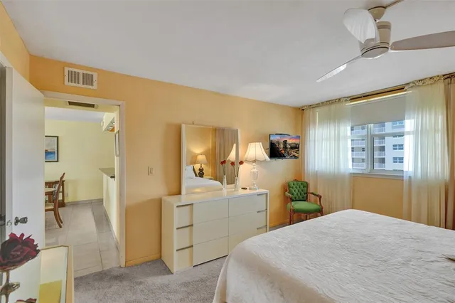 a bedroom with a bed and a painting on the wall