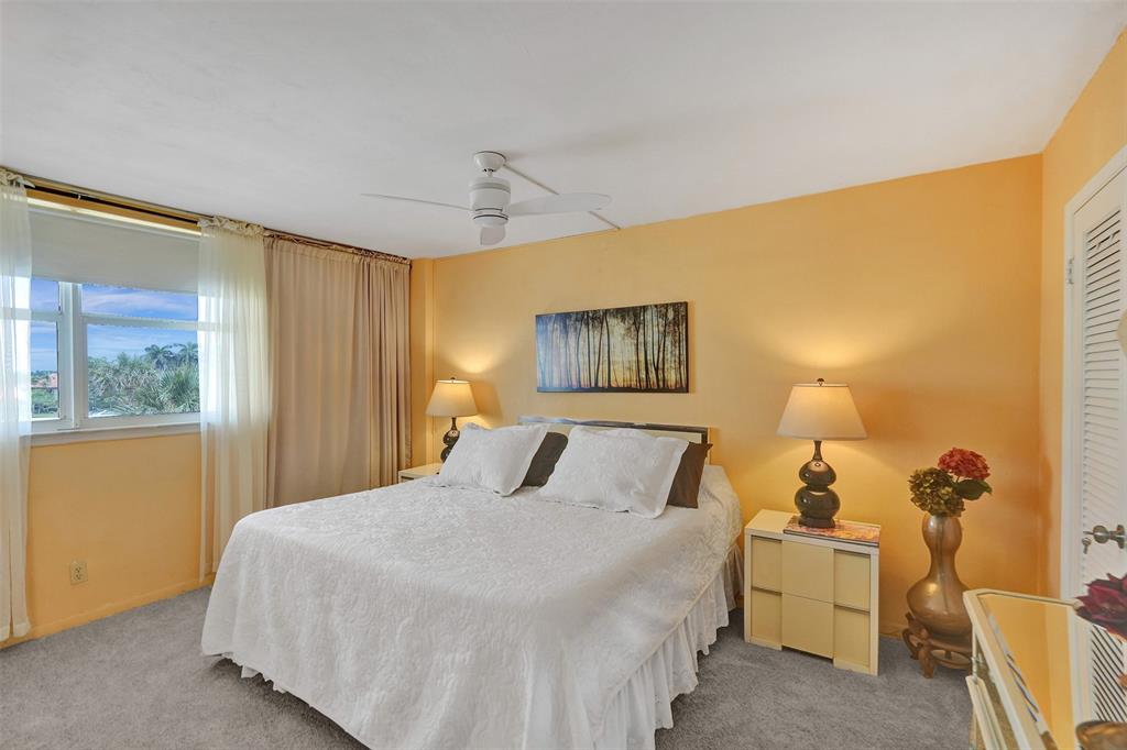 1051 Hillsboro Mile, Unit 307E Hillsboro Beach, FL 33062 - Photo 16 of 30 a bedroom with a bed and a painting on the wall