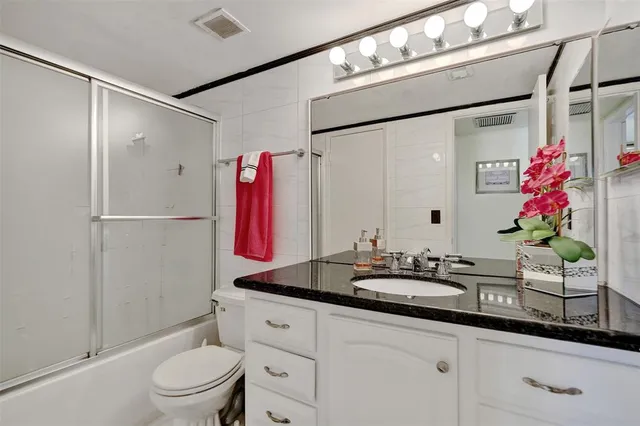a bathroom with a shower and a sink