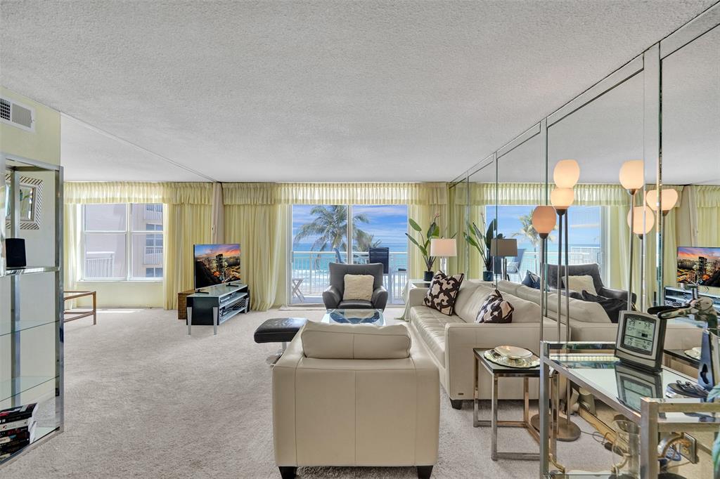 1051 Hillsboro Mile, Unit 307E Hillsboro Beach, FL 33062 - Photo 4 of 30 a living room with fireplace furniture and a large window