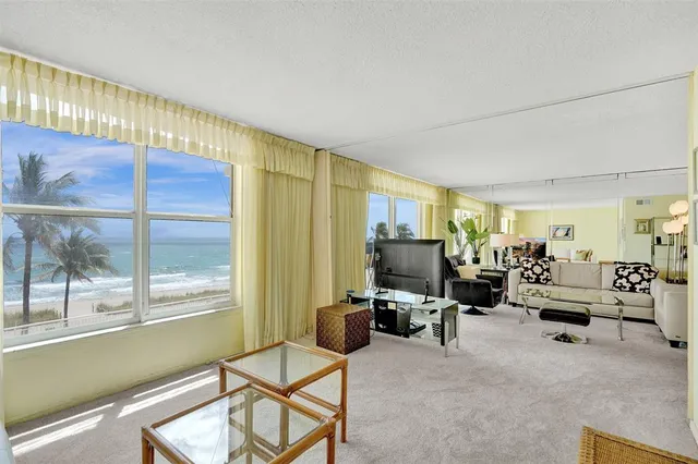 a living room with furniture gym equipment and a large window