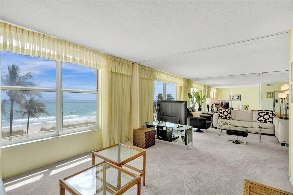 1051 Hillsboro Mile, Unit 307E Hillsboro Beach, FL 33062 - Photo 6 of 30 a living room with furniture gym equipment and a large window