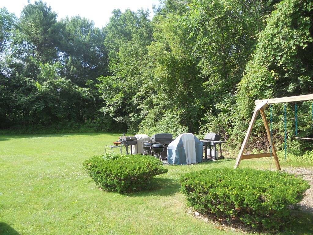 65 Leonard Road, Unit 65 Boxborough, MA 01719 - Photo 14 of 14 a view of a backyard with table and chairs