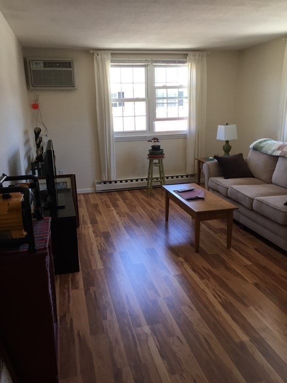 65 Leonard Road, Unit 65 Boxborough, MA 01719 - Photo 3 of 14 a living room with furniture and wooden floor