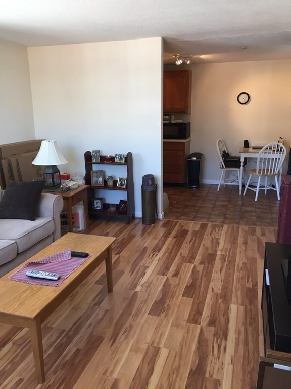 65 Leonard Road, Unit 65 Boxborough, MA 01719 - Photo 4 of 14 a living room with furniture and a wooden floor
