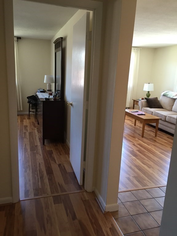 65 Leonard Road, Unit 65 Boxborough, MA 01719 - Photo 5 of 14 a living room with furniture and a wooden floor