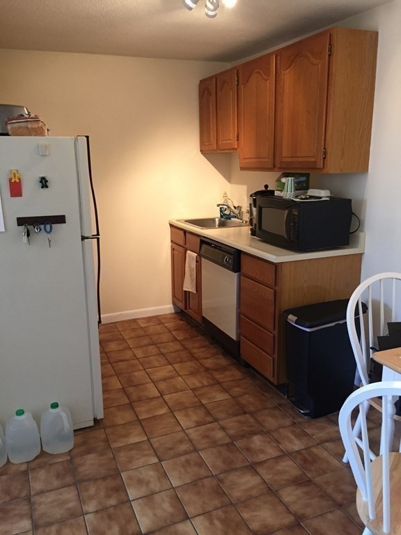 65 Leonard Road, Unit 65 Boxborough, MA 01719 - Photo 7 of 14 a kitchen with a cabinets and appliances