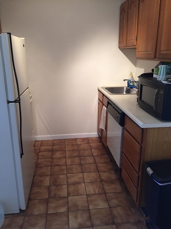 65 Leonard Road, Unit 65 Boxborough, MA 01719 - Photo 8 of 14 a kitchen with a sink and cabinets