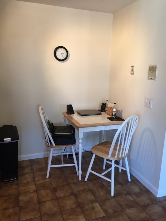 65 Leonard Road, Unit 65 Boxborough, MA 01719 - Photo 10 of 14 a dining room with furniture and a mirror