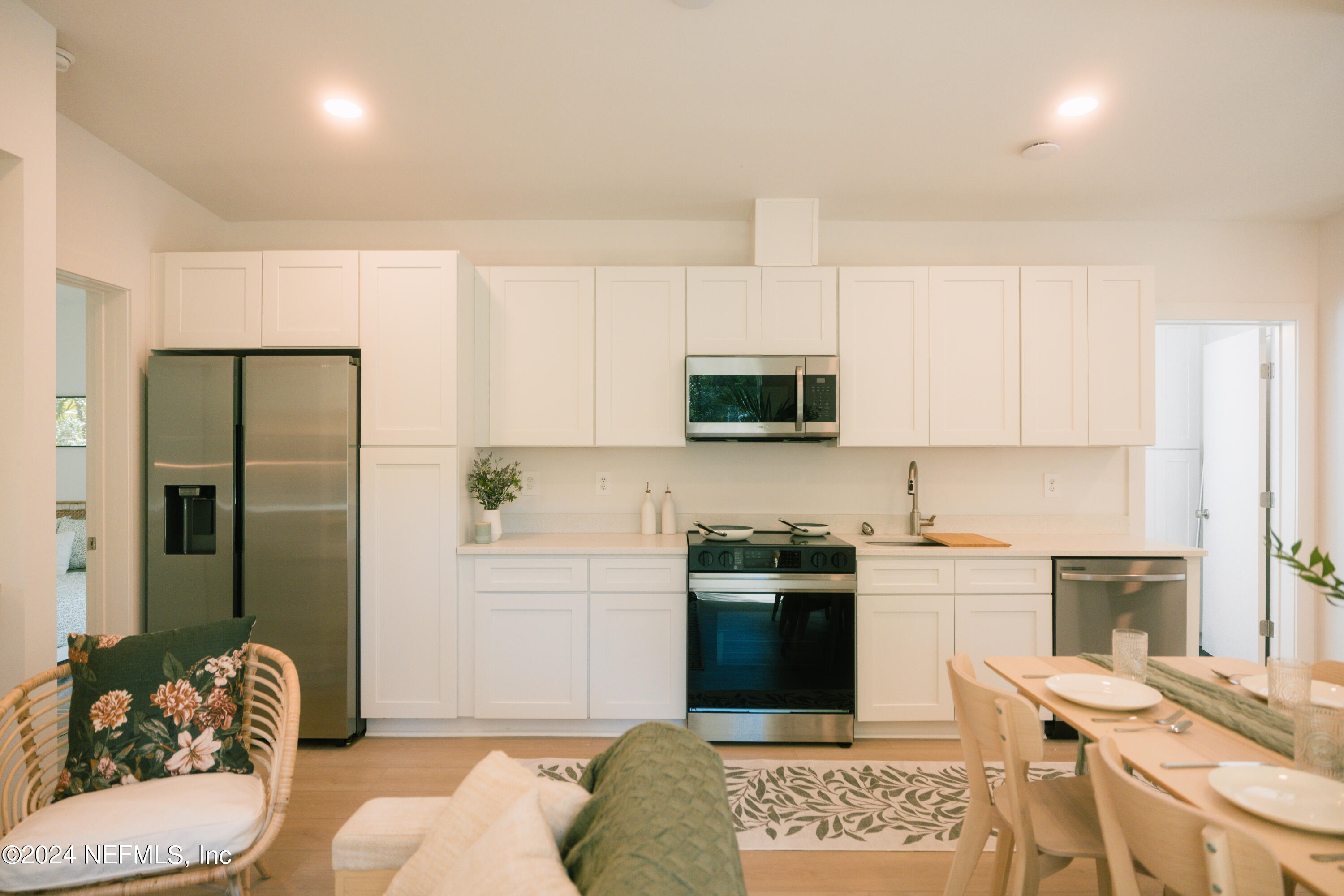 793 Chapin Street St. Augustine, FL 32084 - Photo 12 of 32 a kitchen with stainless steel appliances kitchen island granite countertop a sink and cabinets