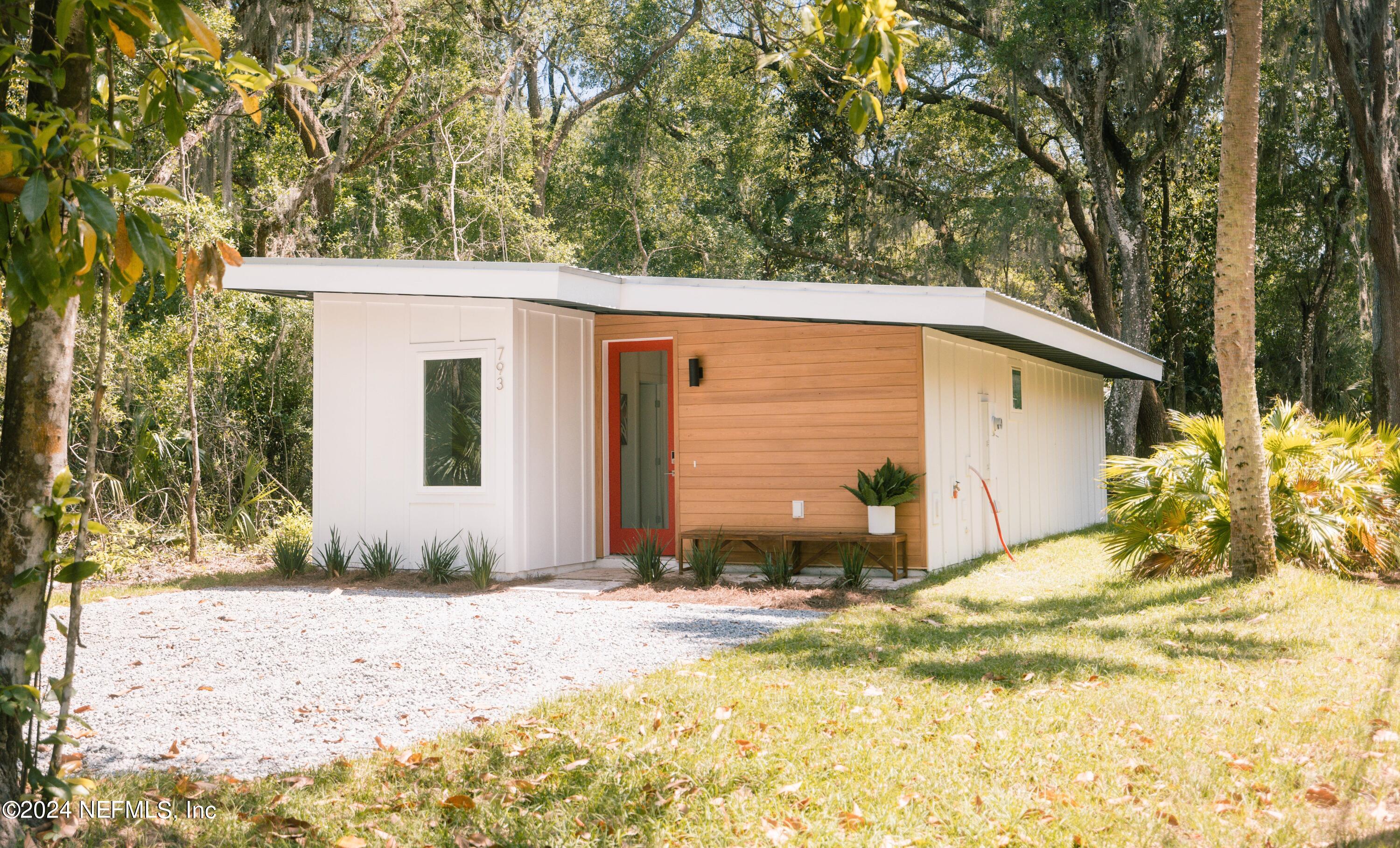 793 Chapin Street St. Augustine, FL 32084 - Photo 2 of 32 a view of a house with backyard and trees