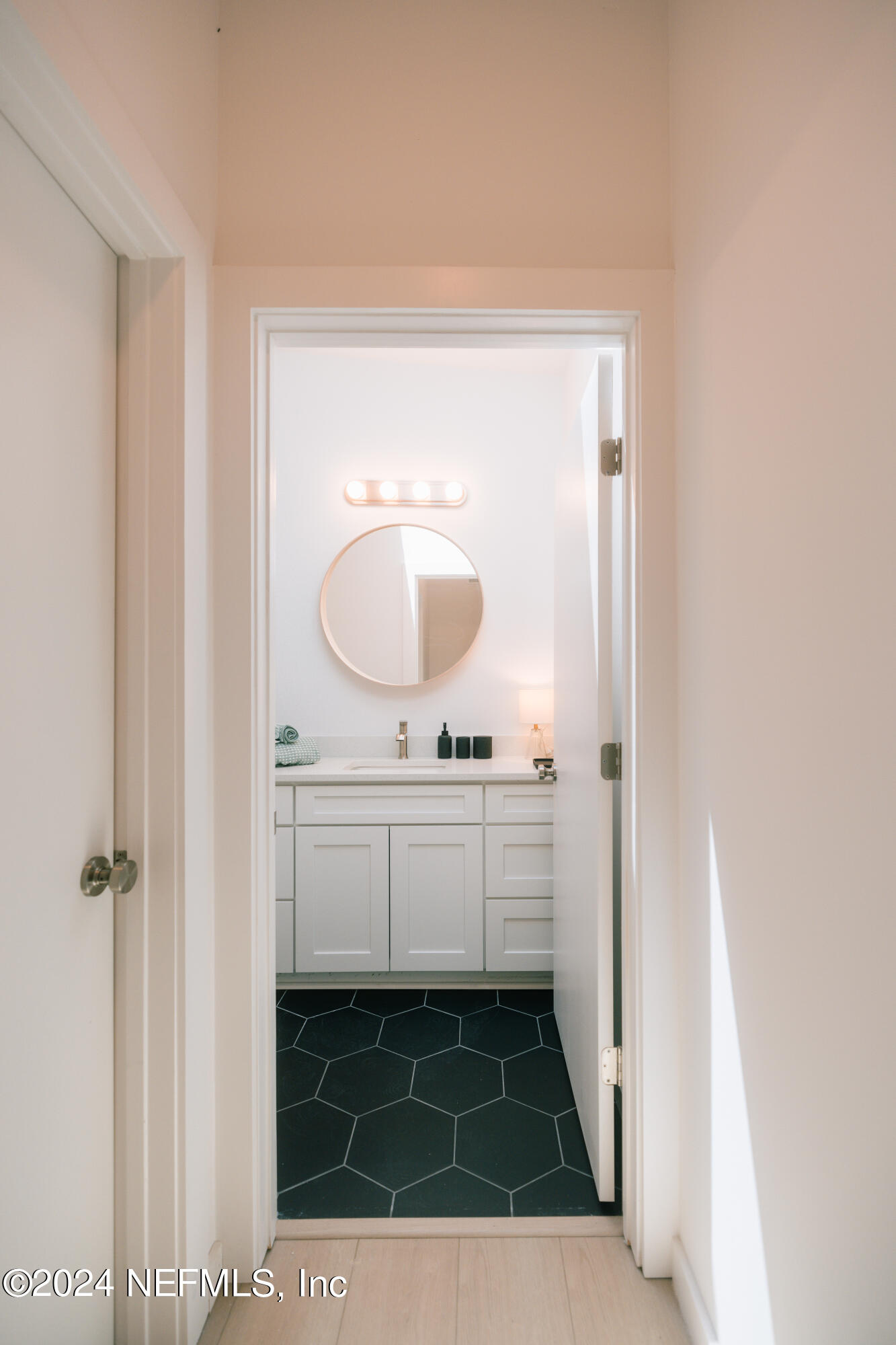 793 Chapin Street St. Augustine, FL 32084 - Photo 26 of 32 a bathroom with a sink and a mirror