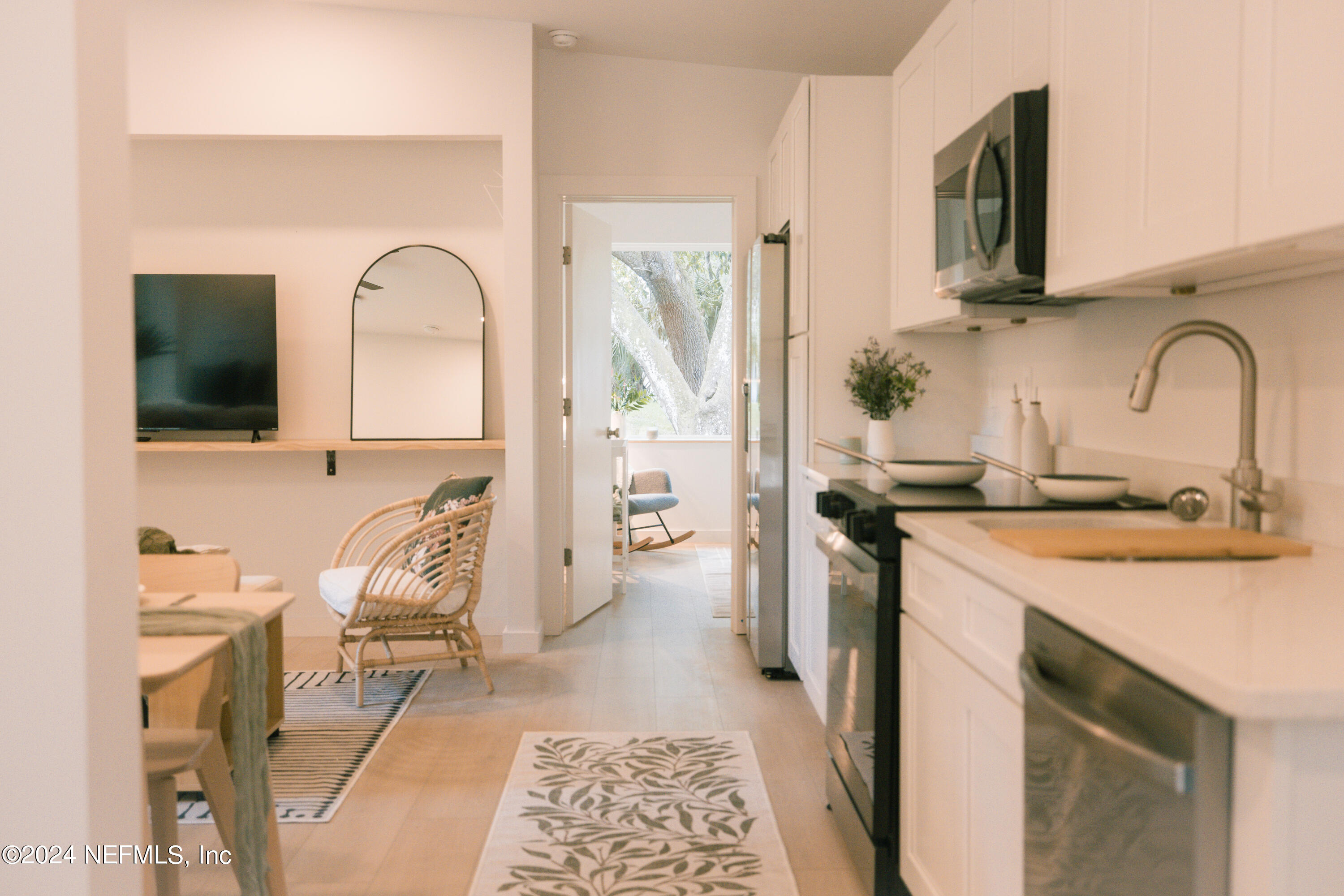 793 Chapin Street St. Augustine, FL 32084 - Photo 5 of 32 a kitchen with a sink cabinets and stainless steel appliances