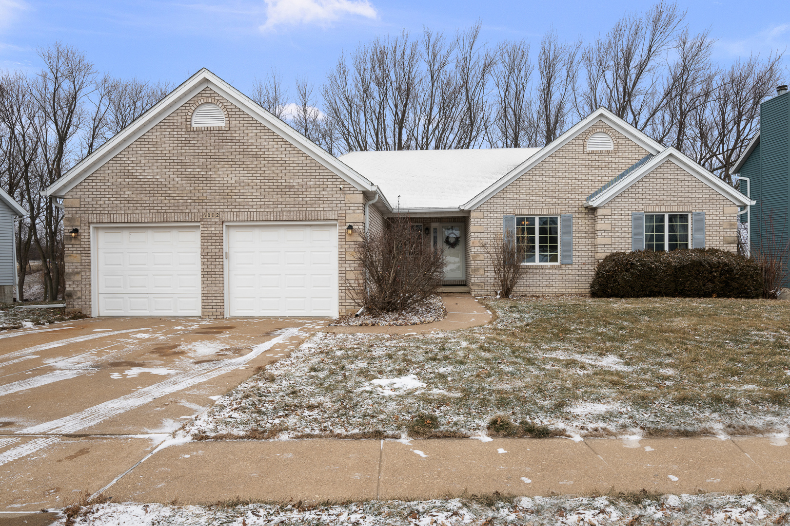 6002 Oakbrook Road Davenport, IA 52806 - Photo 1 of 50 a front view of a house with a yard and garage
