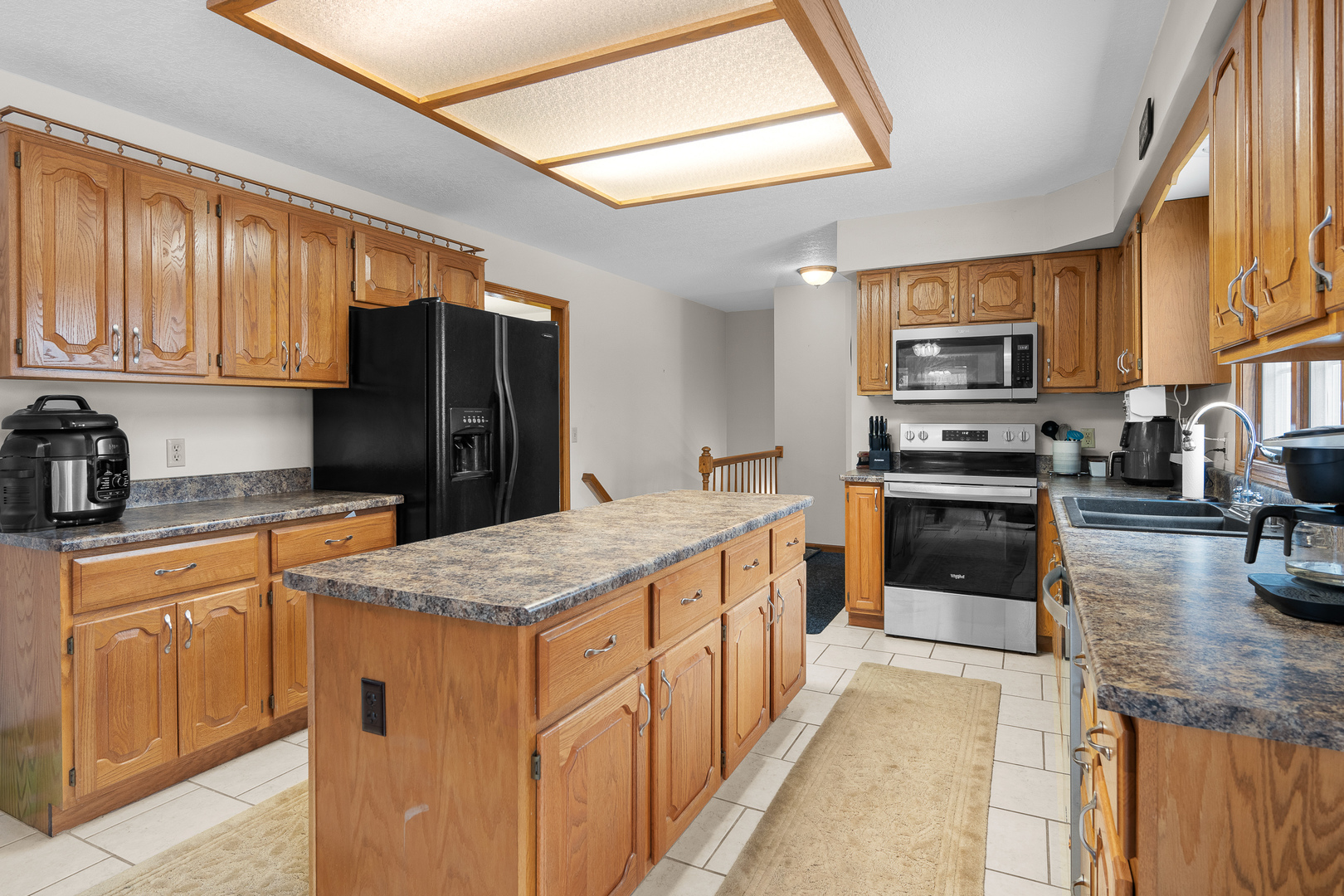 6002 Oakbrook Road Davenport, IA 52806 - Photo 11 of 50 a kitchen with stainless steel appliances granite countertop a refrigerator a stove top oven a sink and dishwasher