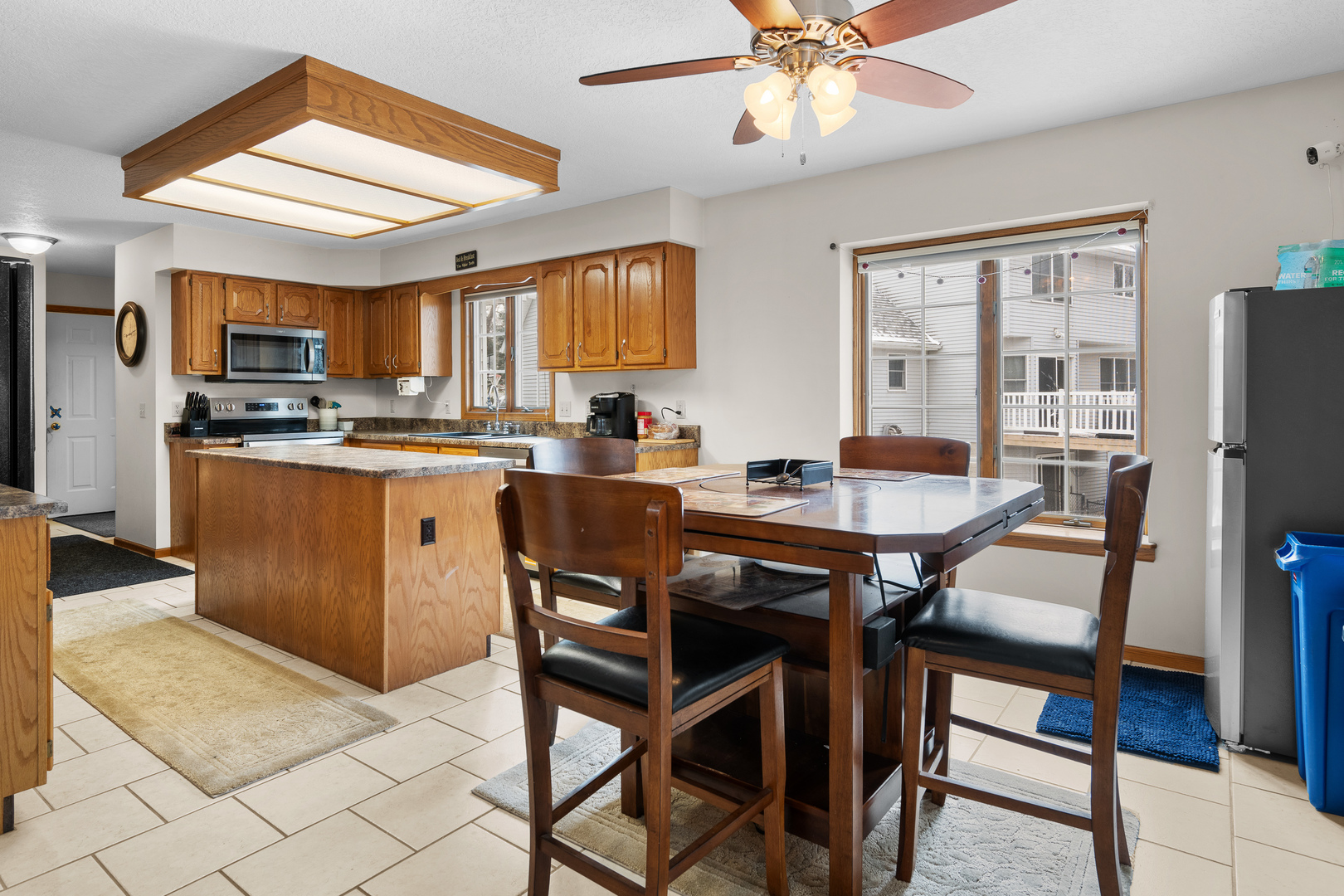 6002 Oakbrook Road Davenport, IA 52806 - Photo 14 of 50 a dining room with a table chairs and a kitchen view