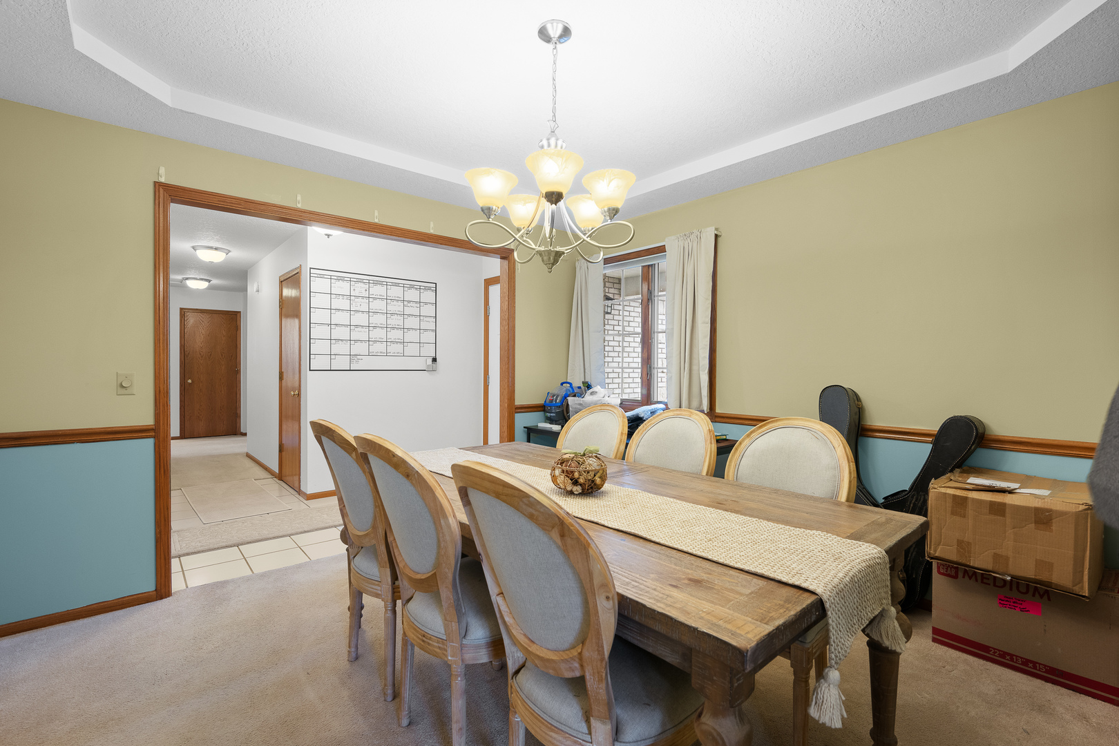 6002 Oakbrook Road Davenport, IA 52806 - Photo 17 of 50 a view of a dining room with furniture and a chandelier