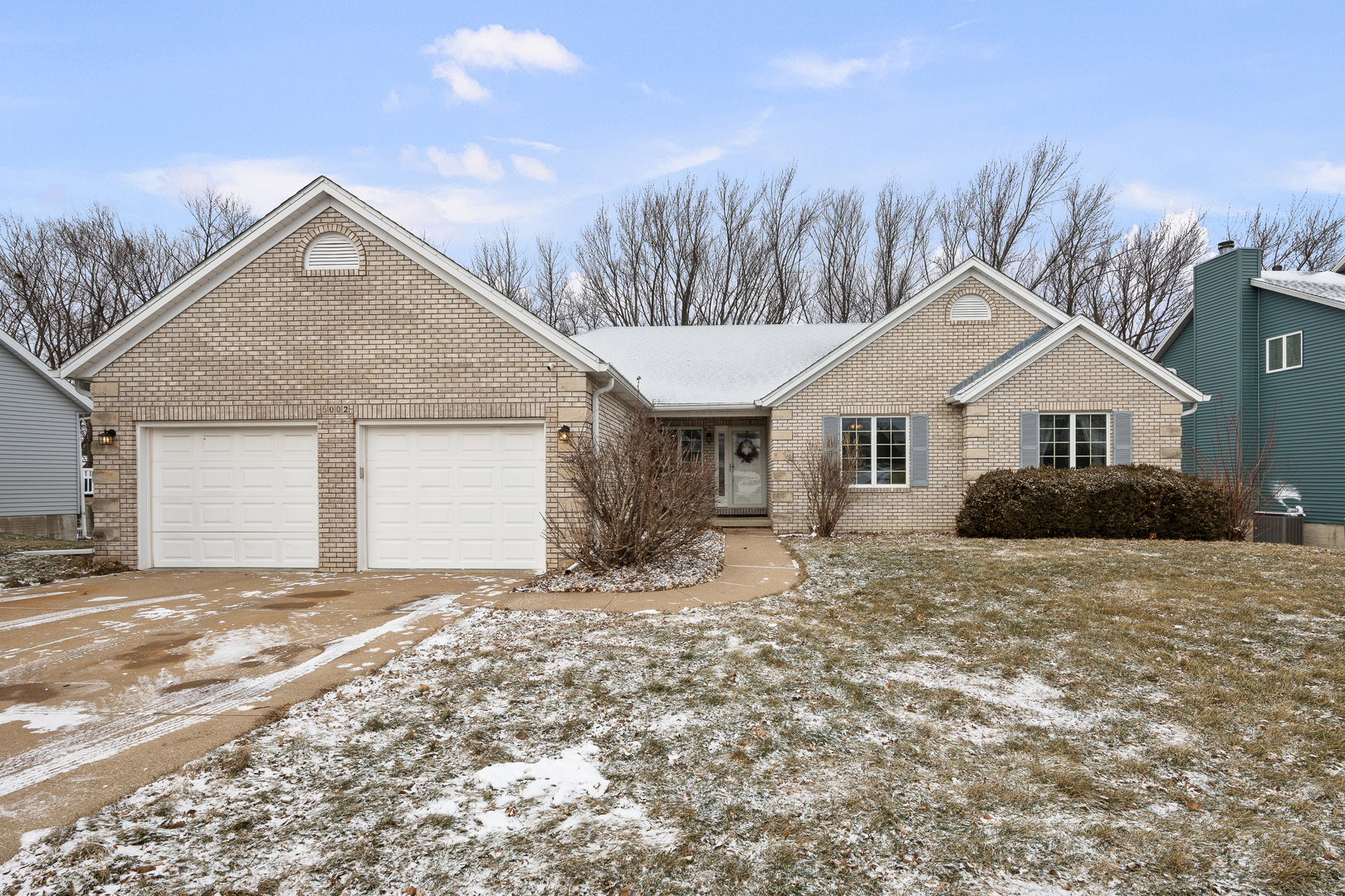 6002 Oakbrook Road Davenport, IA 52806 - Photo 2 of 50 a view of a house with a yard and garage
