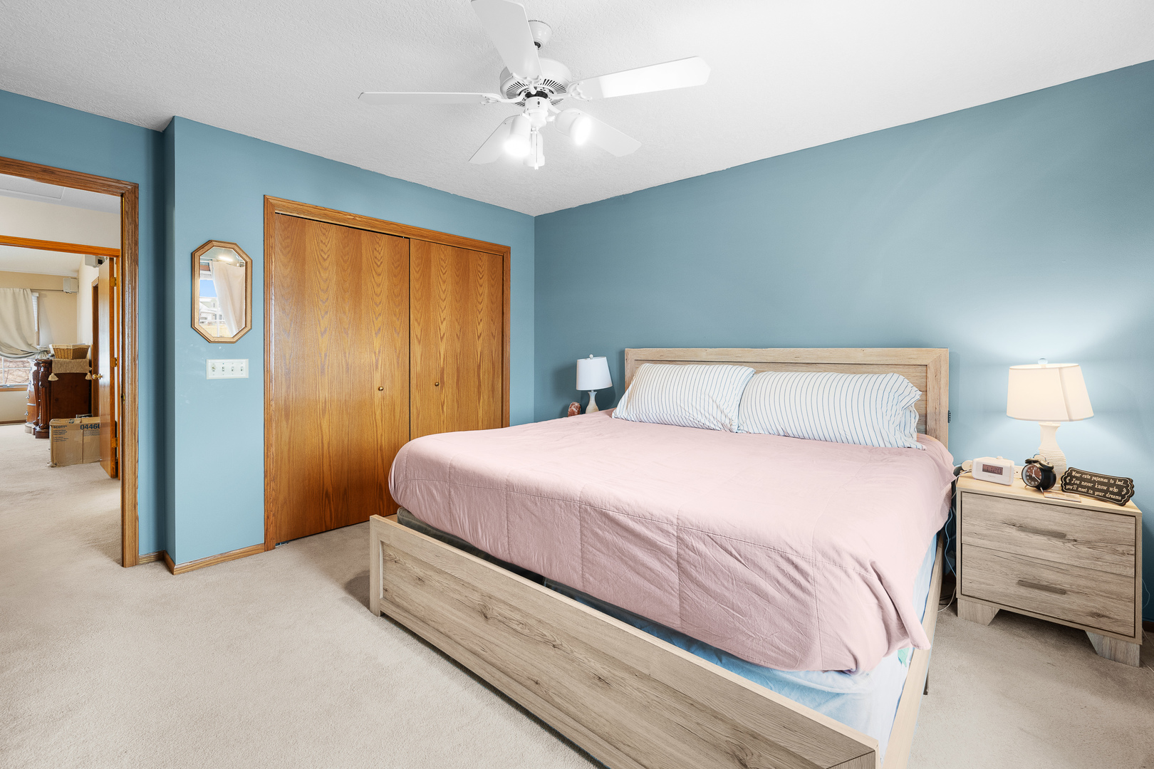 6002 Oakbrook Road Davenport, IA 52806 - Photo 33 of 50 a bedroom with a bed and a chandelier