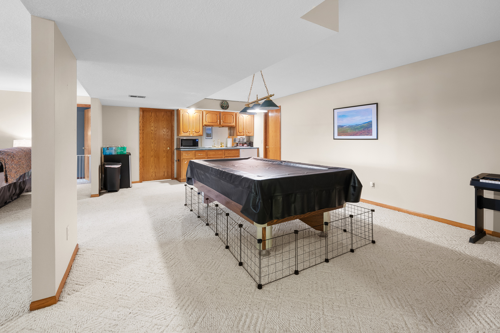 6002 Oakbrook Road Davenport, IA 52806 - Photo 37 of 50 a spacious bedroom with a bed and a table in it
