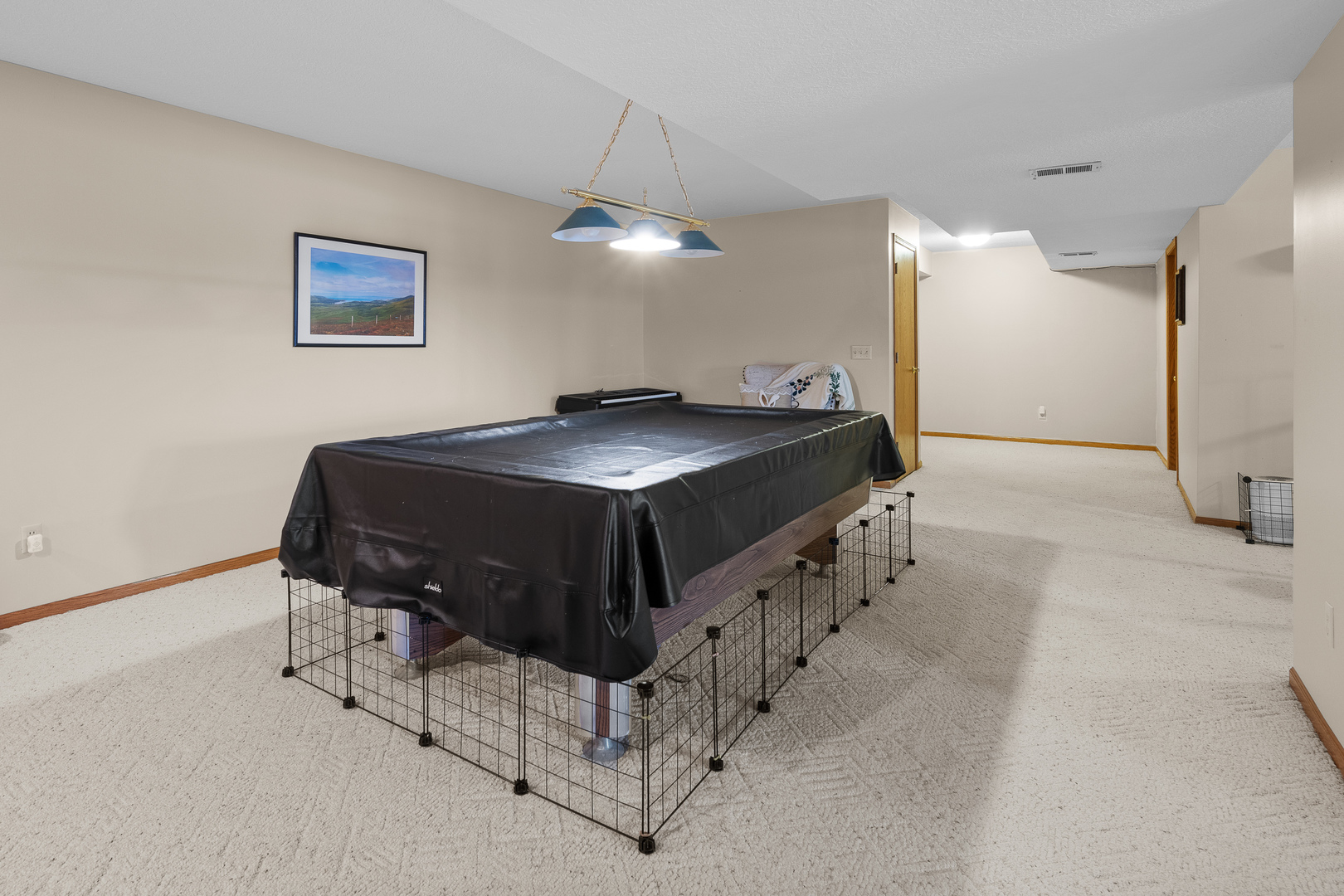 6002 Oakbrook Road Davenport, IA 52806 - Photo 41 of 50 a spacious bedroom with a bed and a chandelier