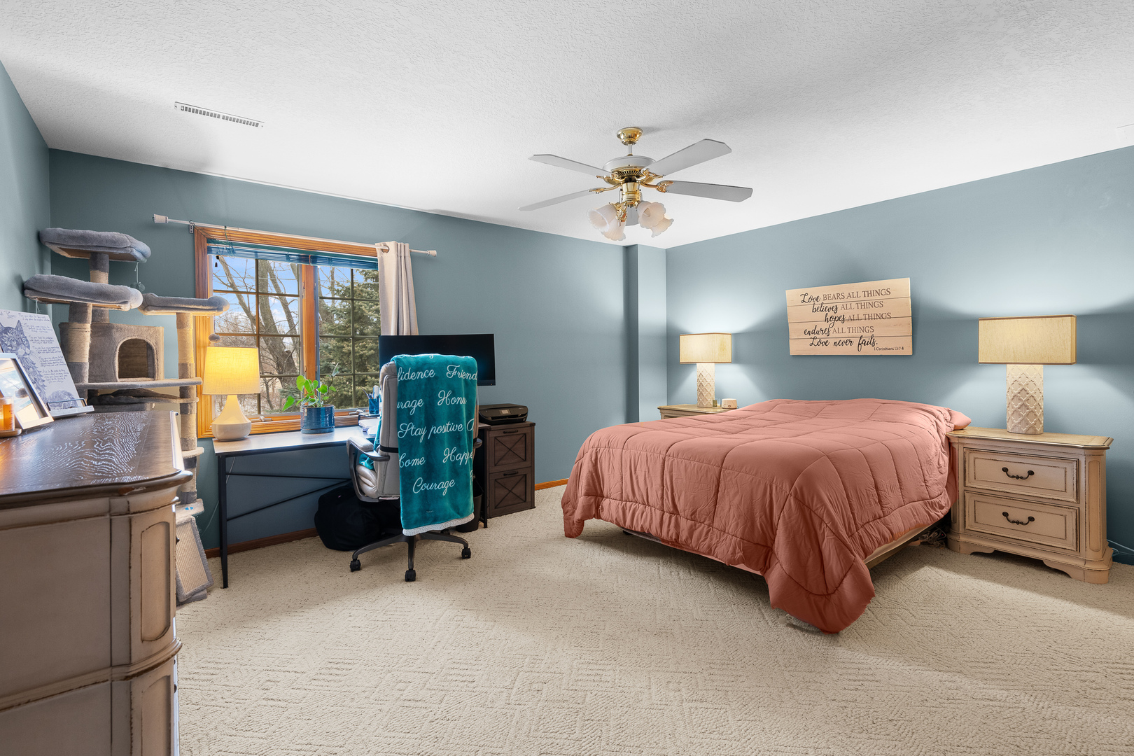 6002 Oakbrook Road Davenport, IA 52806 - Photo 44 of 50 a spacious bedroom with a bed and a chandelier