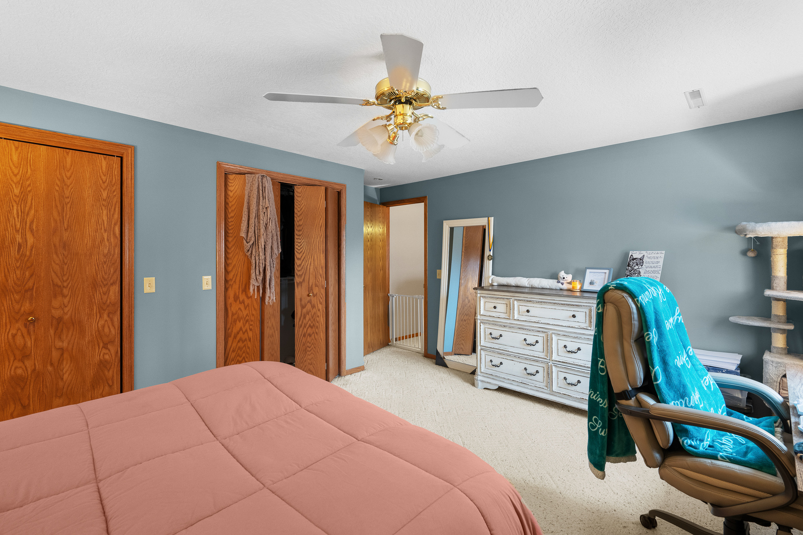 6002 Oakbrook Road Davenport, IA 52806 - Photo 45 of 50 a bedroom with a bed and a chandelier