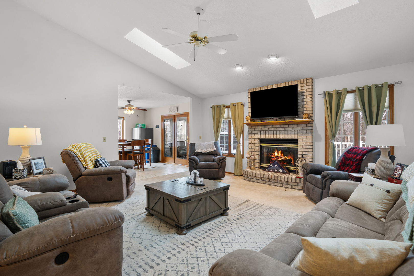 6002 Oakbrook Road Davenport, IA 52806 - Photo 6 of 50 a living room with furniture a fireplace and a flat screen tv