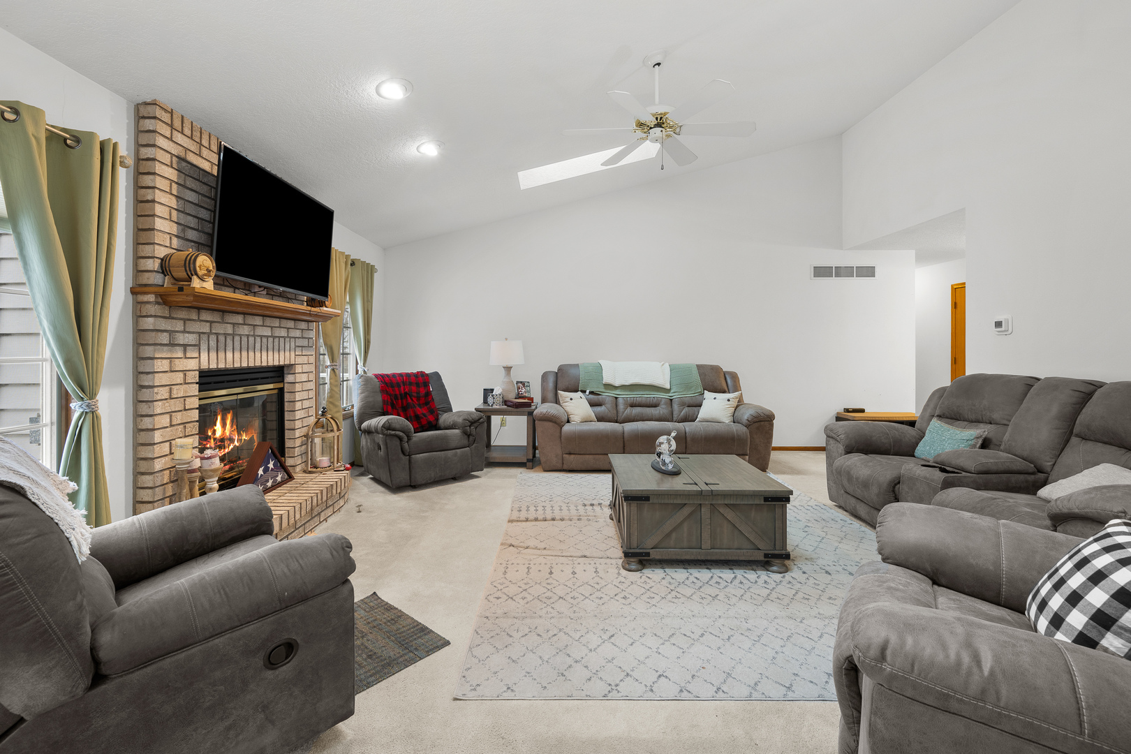 6002 Oakbrook Road Davenport, IA 52806 - Photo 7 of 50 a living room with furniture a fireplace and a flat screen tv