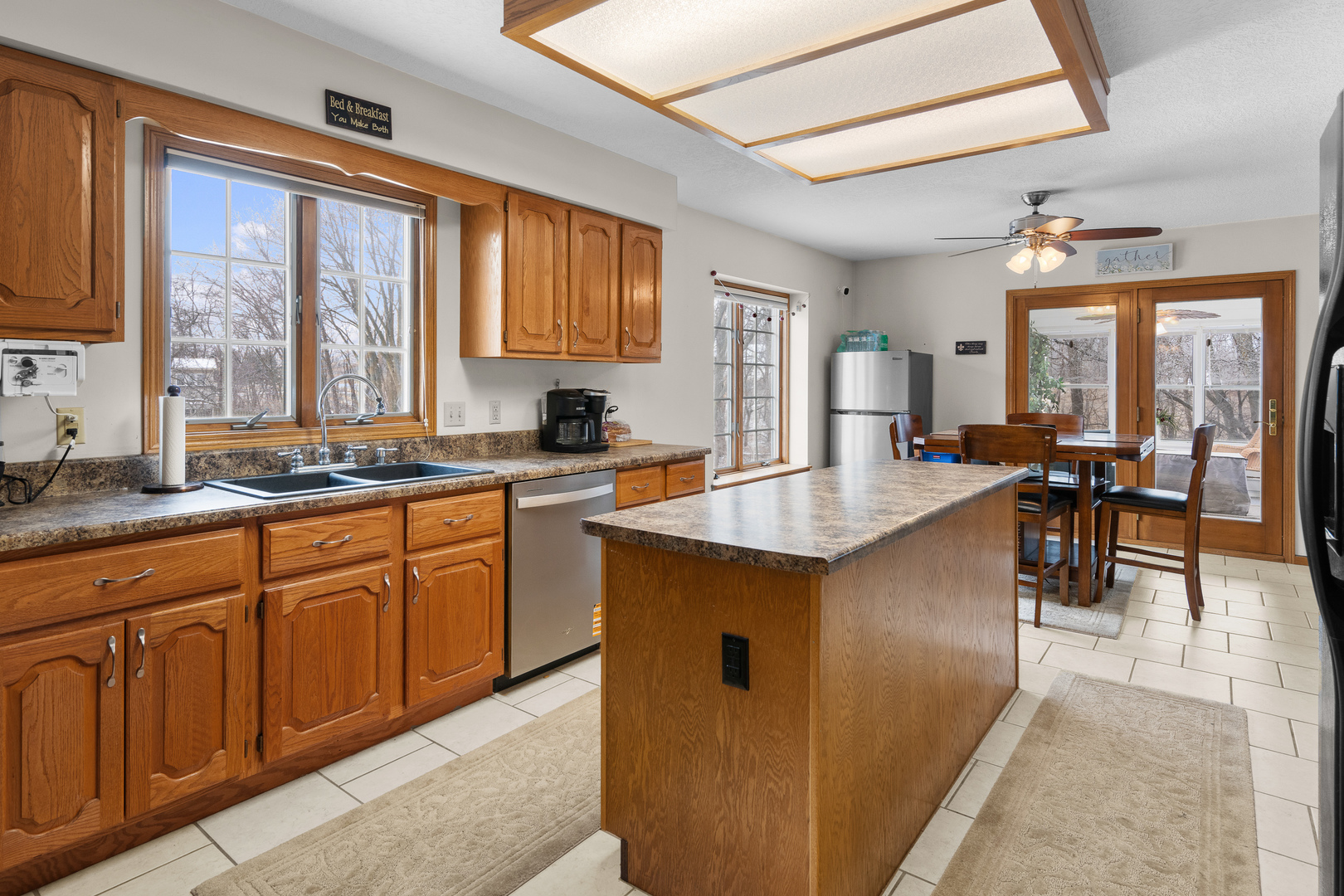 6002 Oakbrook Road Davenport, IA 52806 - Photo 10 of 50 a kitchen with stainless steel appliances granite countertop a sink a stove and a refrigerator