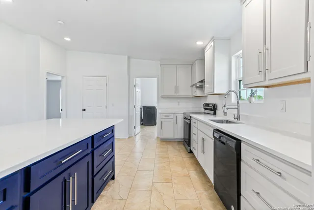 a kitchen with cabinets and appliances