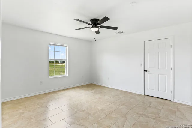 a view of a livingroom with a ceiling fan and window