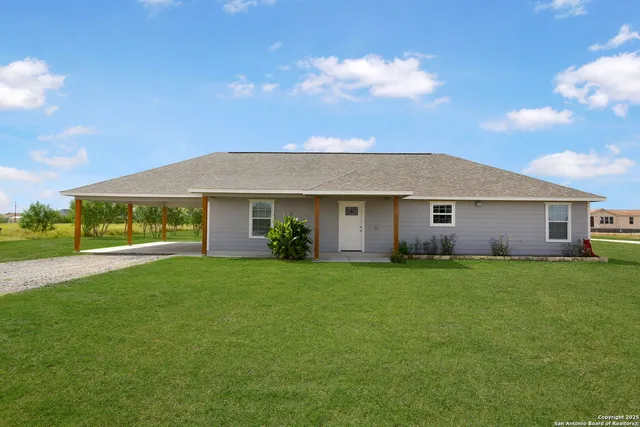 a front view of house with yard and green space
