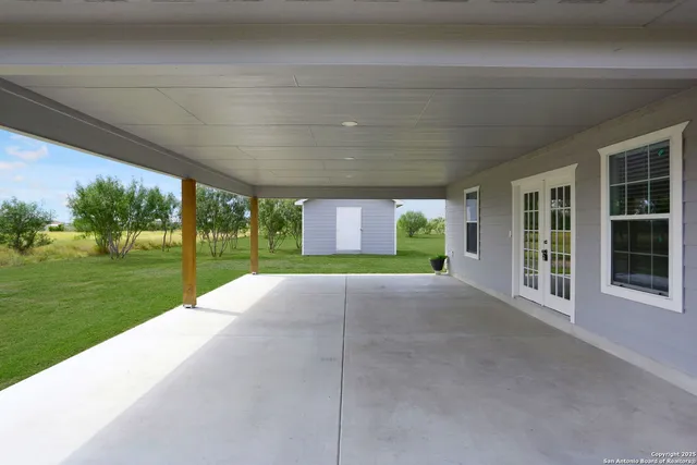 an aerial view of a house with a lake view