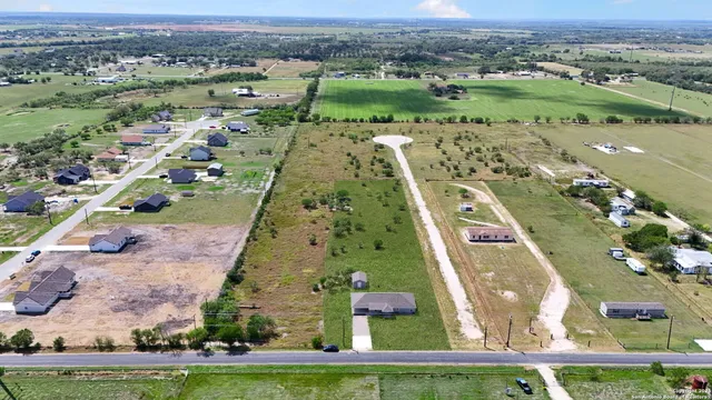 an aerial view of a residential houses with outdoor space