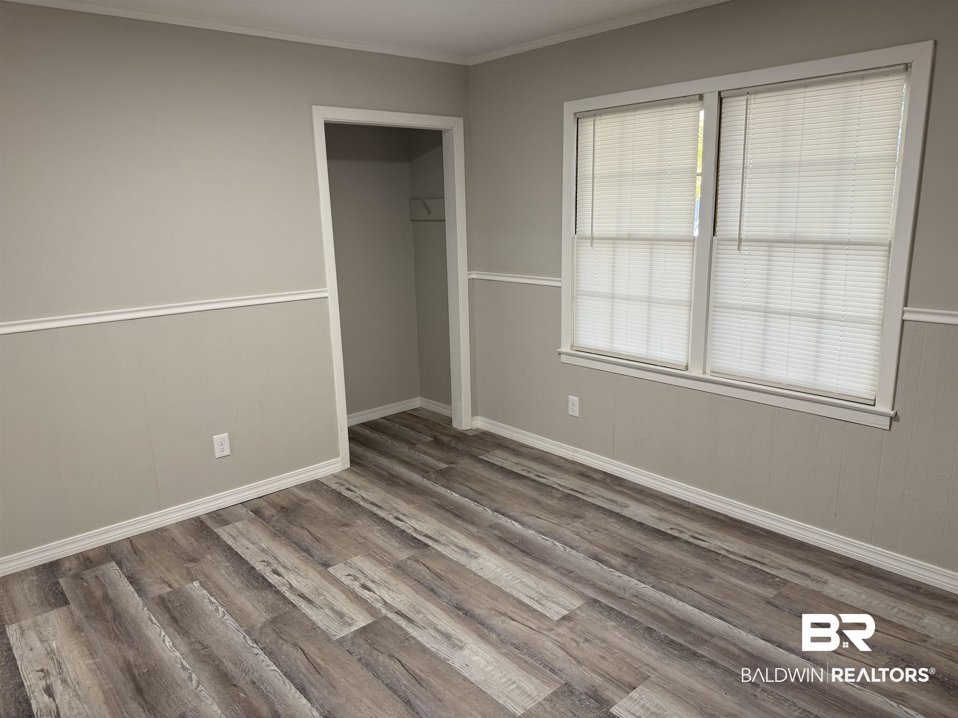114 Spruce Avenue Brewton, AL 36426 - Photo 6 of 13 Unfurnished bedroom with ornamental molding, wood finished floors, and a closet