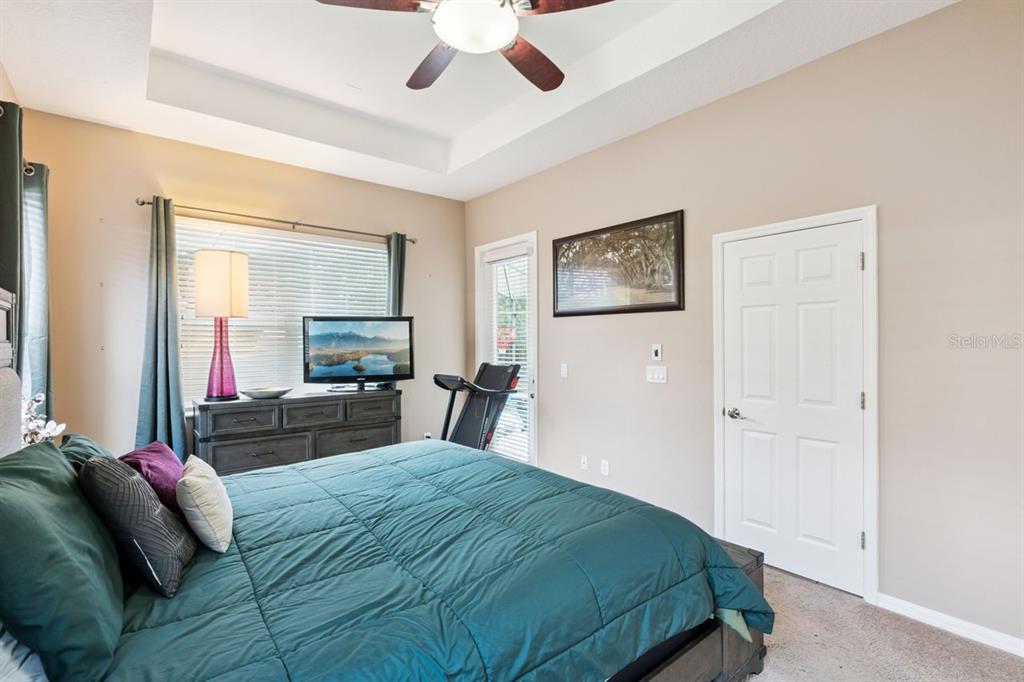 8484 Dover View Lane Orlando, FL 32829 - Photo 11 of 41 a bedroom with a large bed and a large mirror