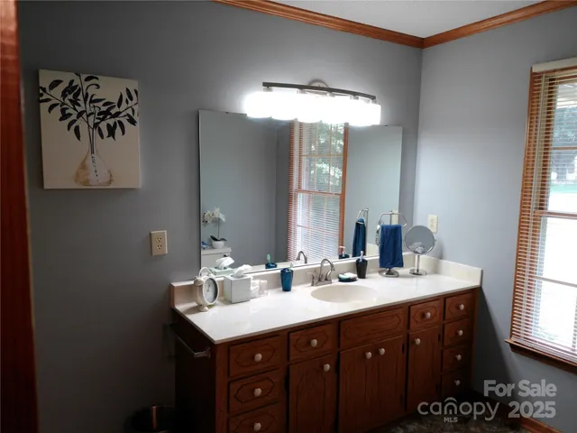 a bathroom with a double vanity sink and a mirror