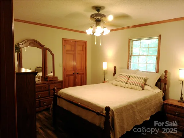 a bedroom with a bed and a chandelier