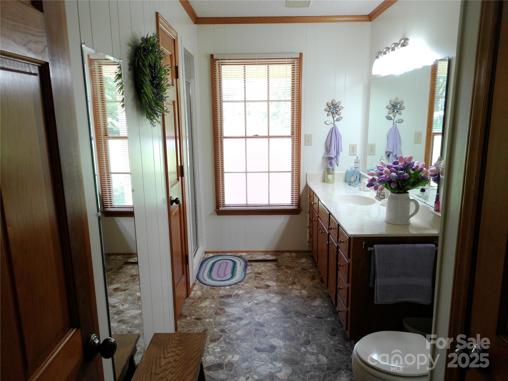 216 Williams Road Harrisburg, NC 28075 - Photo 20 of 28 a bathroom with a sink a toilet and mirror