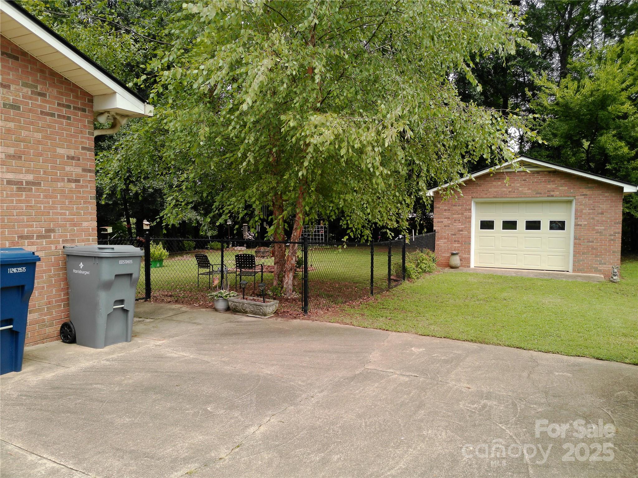216 Williams Road Harrisburg, NC 28075 - Photo 3 of 28 a backyard of a house with table and chairs